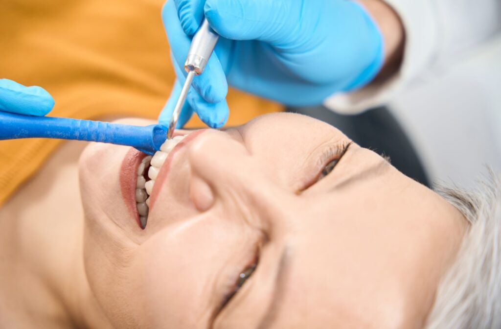 A person getting their teeth cleaned using the new airflow dental tool